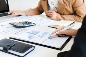 People at work table with charts